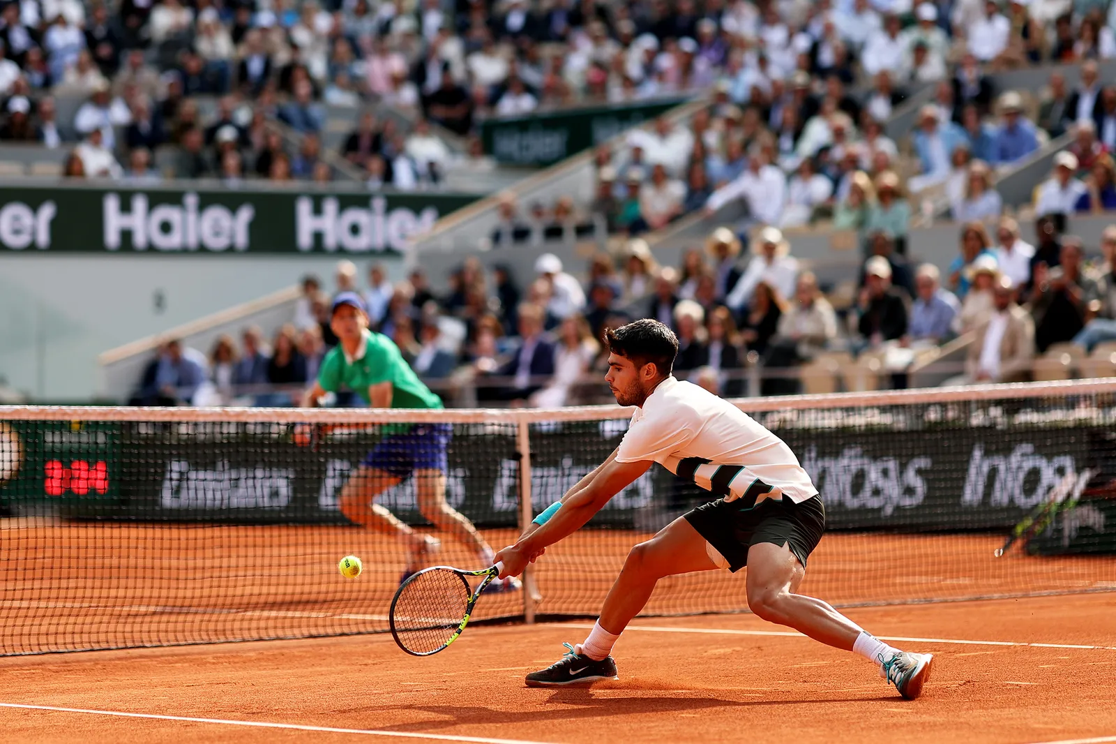 Carlos Alcaraz and Jannik Sinner facing off on court